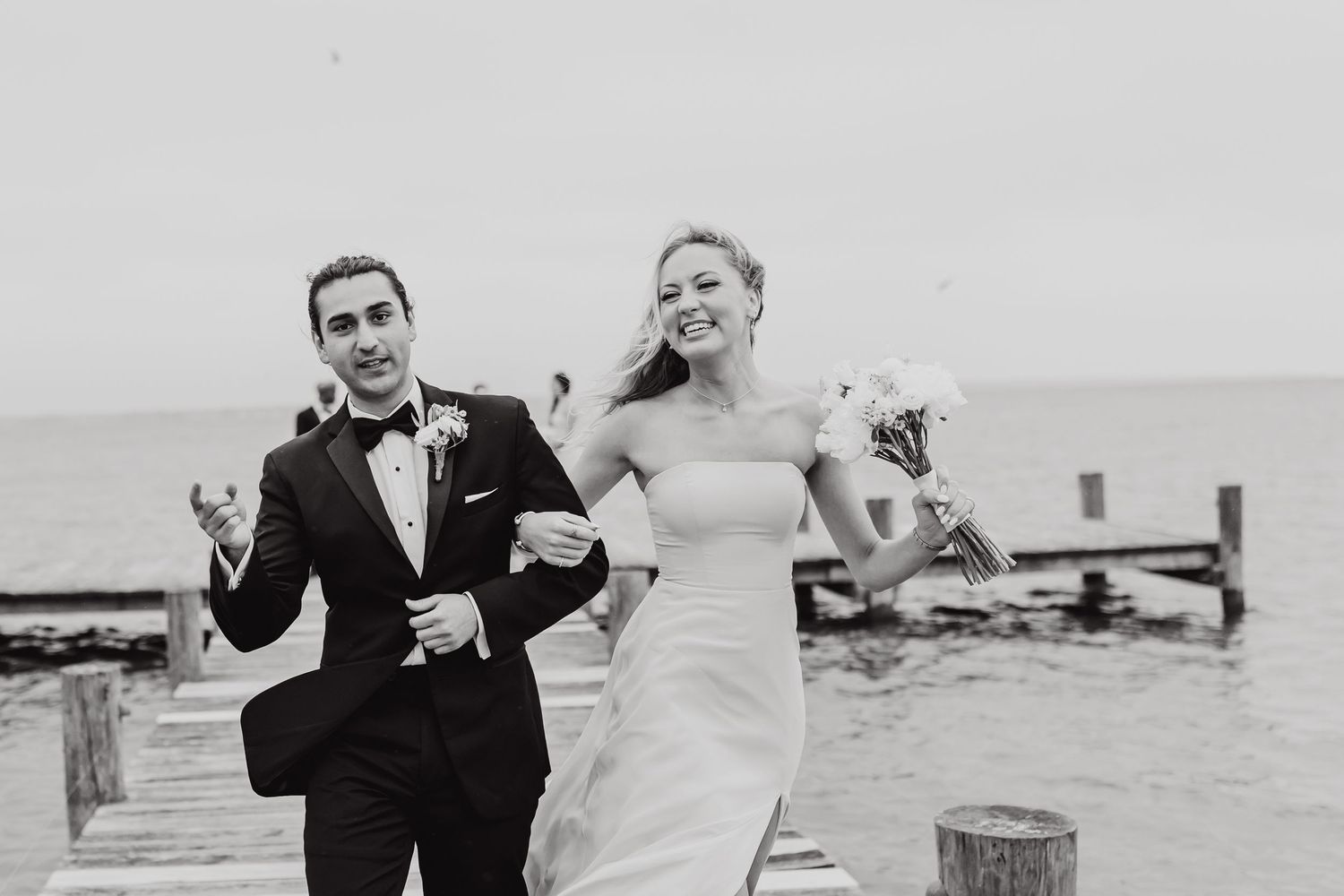 A black and white photo sequence captures joyful moments between a couple on their wedding day.