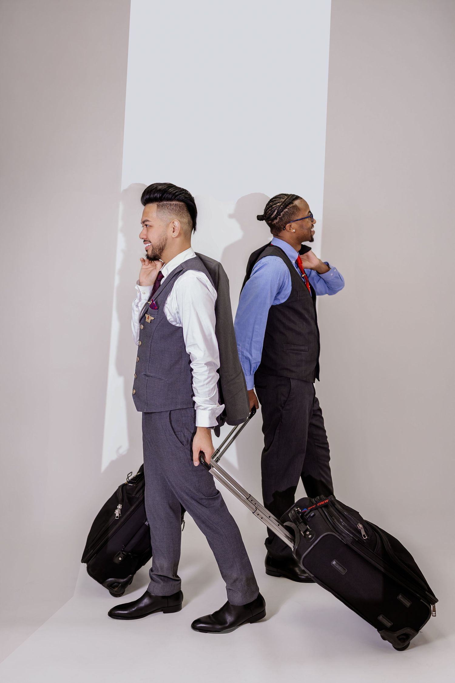 A sequence of business professionals walking with luggage through a white hallway shown in multiple frames.