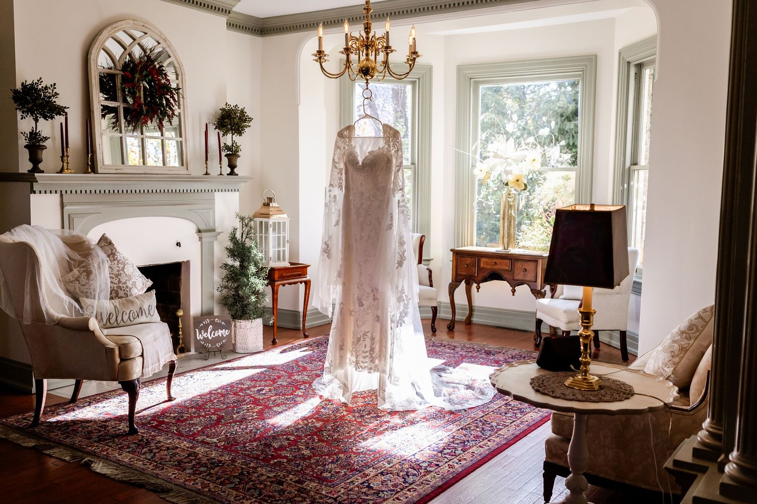 Elegant bridal boutique interior with vintage furniture, chandeliers, and natural light streaming through windows.