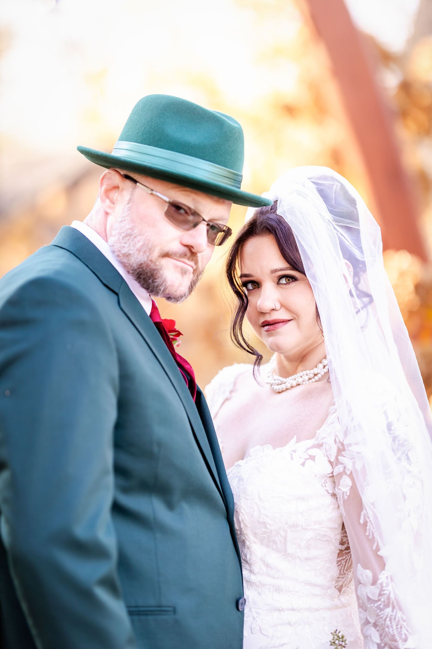 A couple shares an intimate moment during their autumn wedding ceremony.