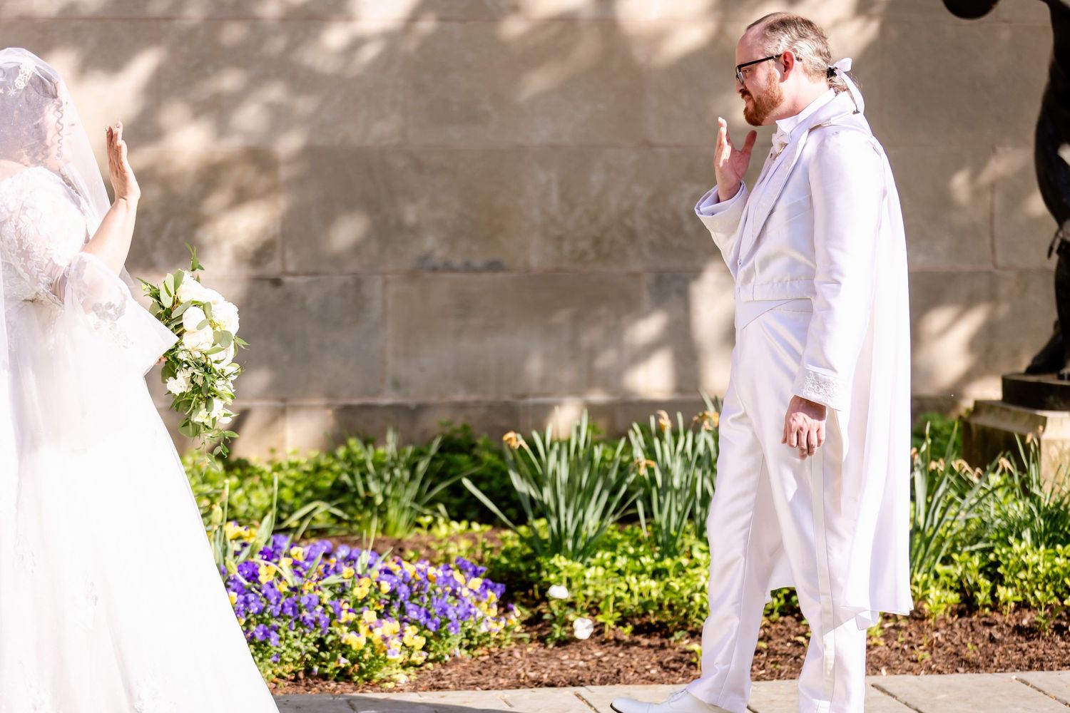 Emotional first look moment between couple during outdoor garden wedding ceremony.