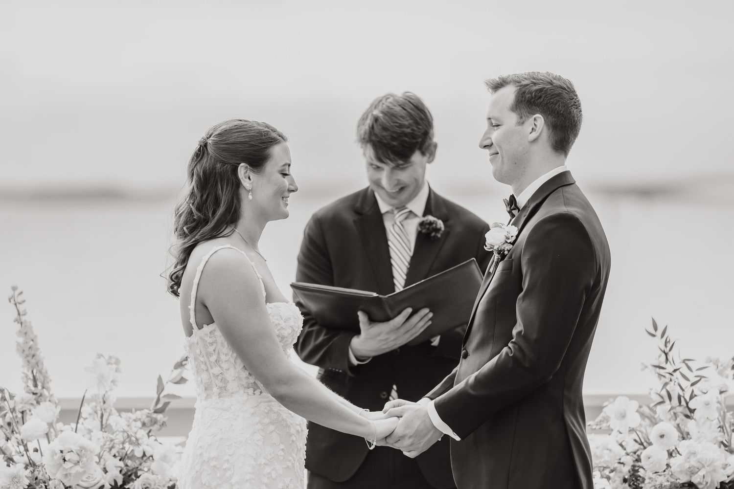 Black and white wedding ceremony photos capturing emotional exchange of vows.