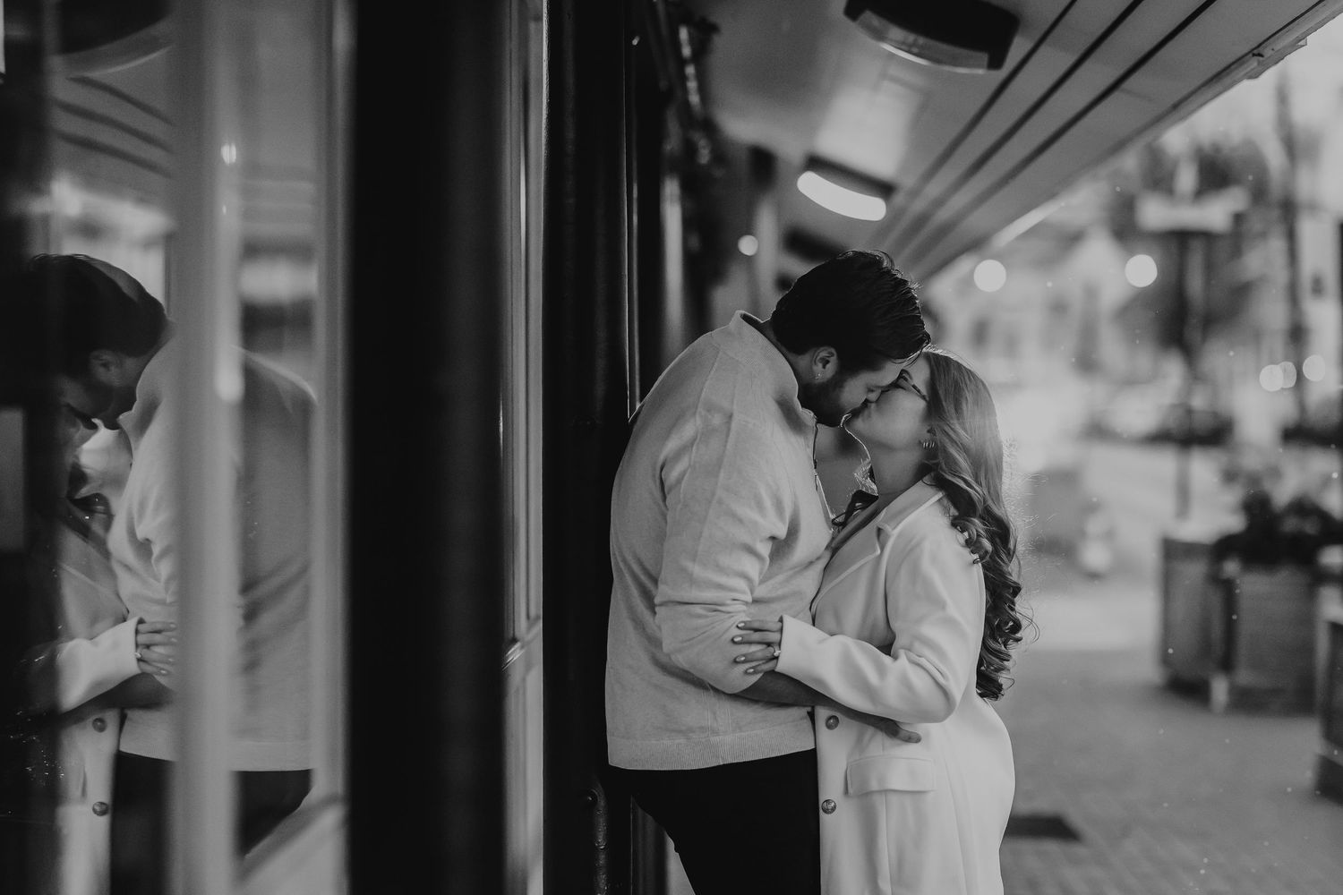 A black and white photo sequence shows a couple sharing an intimate moment in front of a window.
