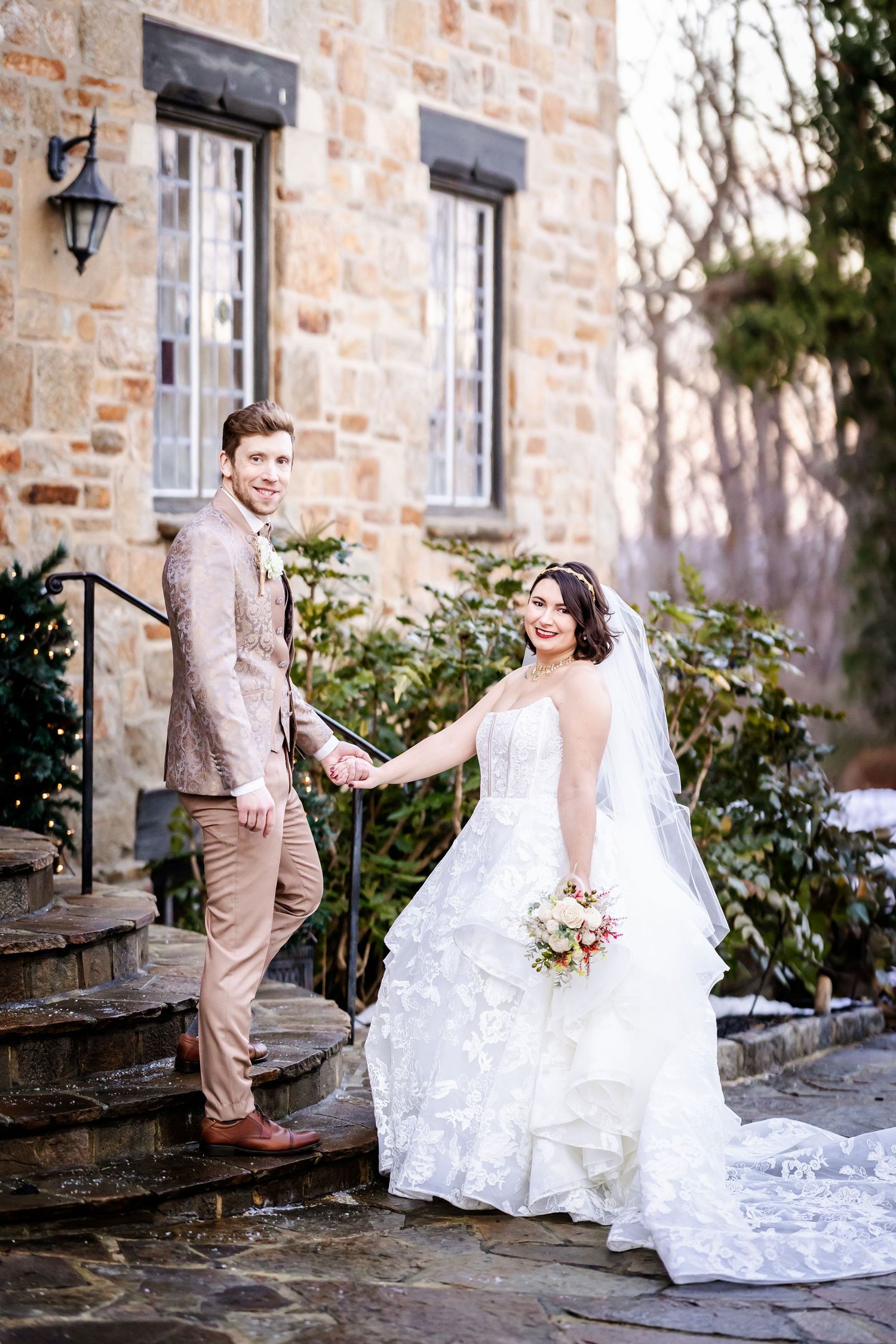 A romantic wedding photo series showing a couple on stone steps outside a rustic brick building in winter.