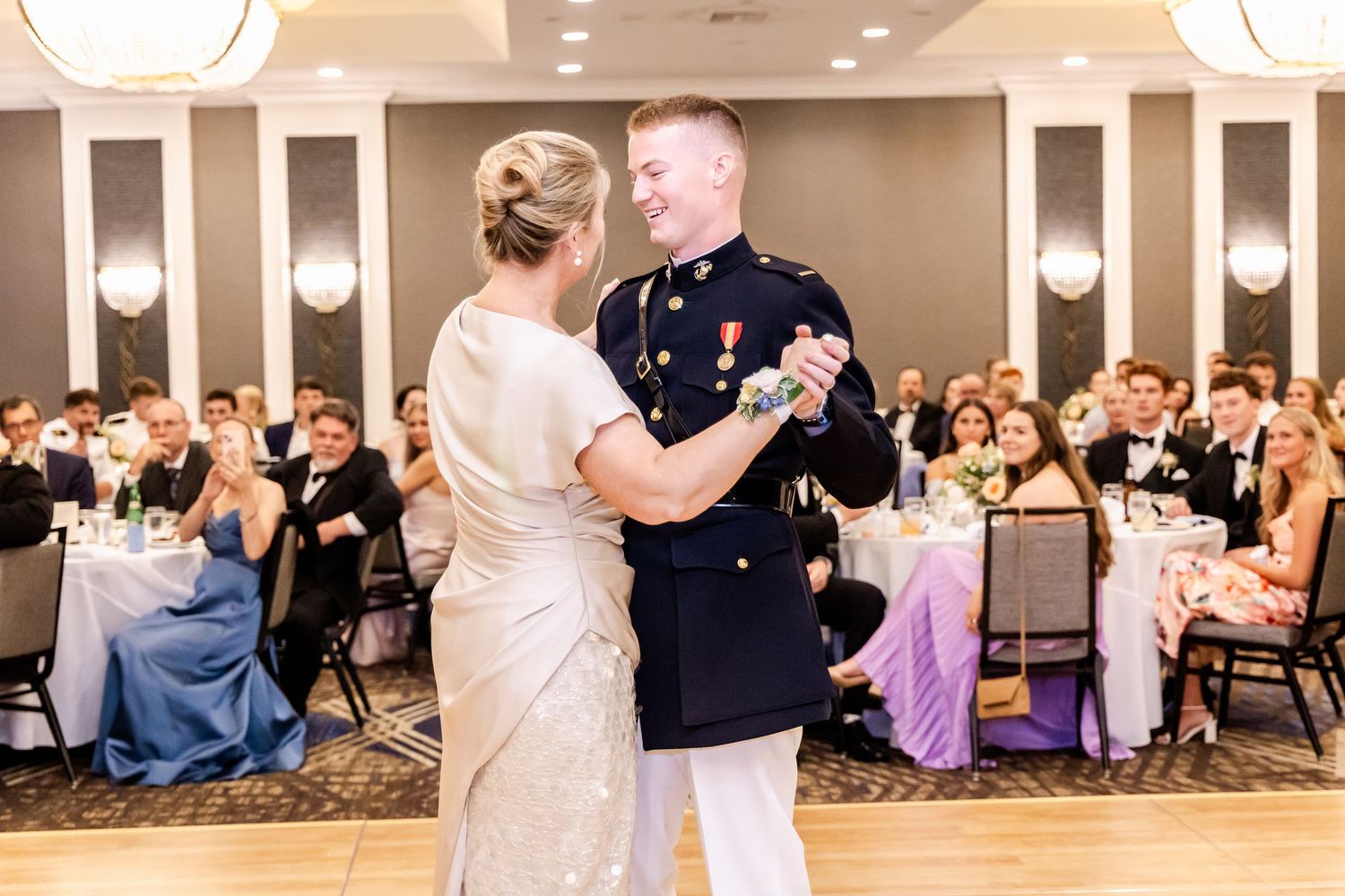 Wedding guests dancing together in a hotel ballroom during an evening celebration.