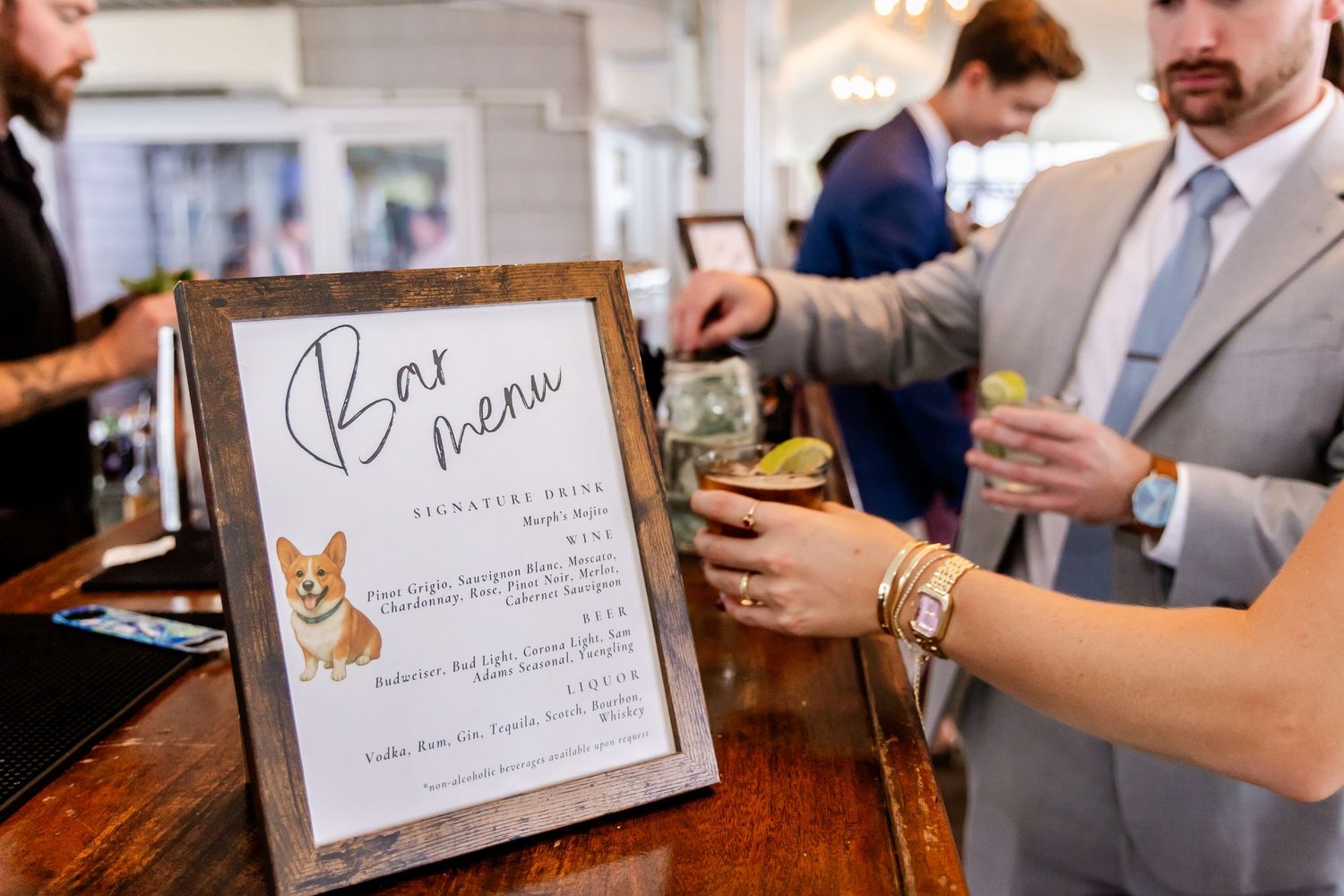 Wedding reception details showing menu cards with corgi dog illustrations.