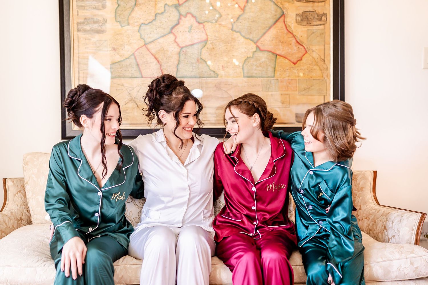 Group in colorful satin robes lounging on antique furniture in an elegant room.