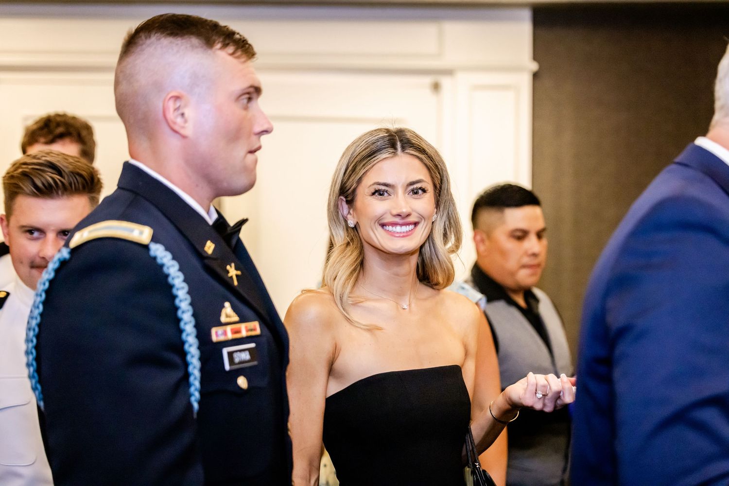 Wedding reception guests mingling and celebrating in formal attire.