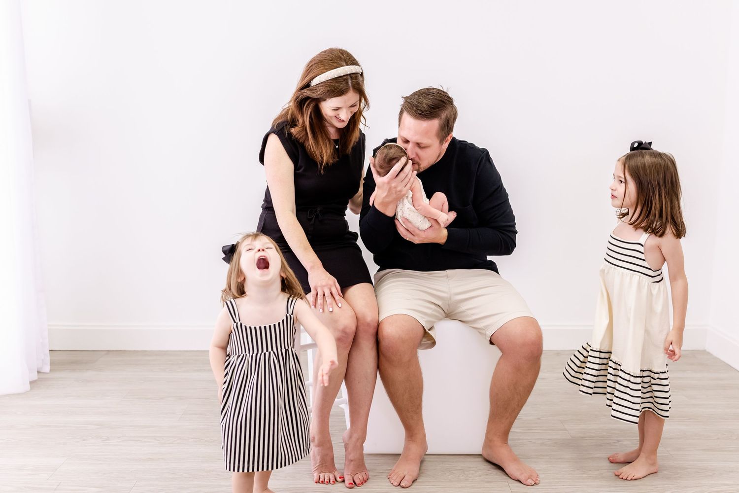 A group of people in coordinated casual outfits pose together against a white background for a lifestyle photoshoot.