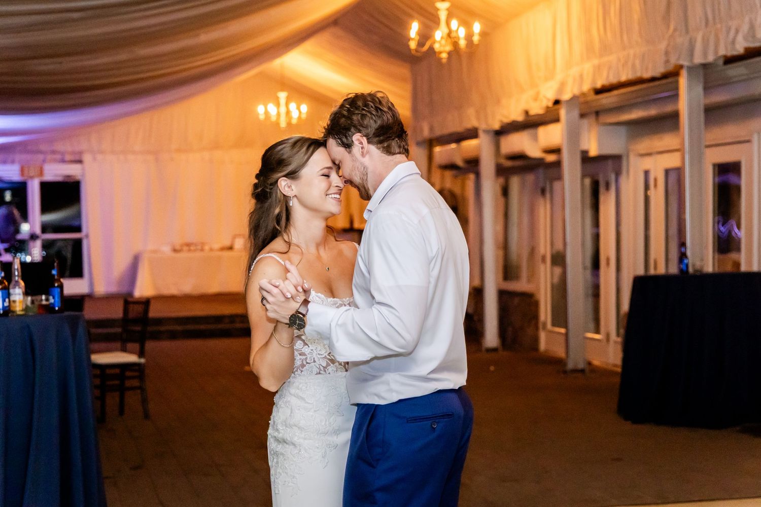 Intimate dance moment captured in warm lighting at an elegant reception venue.