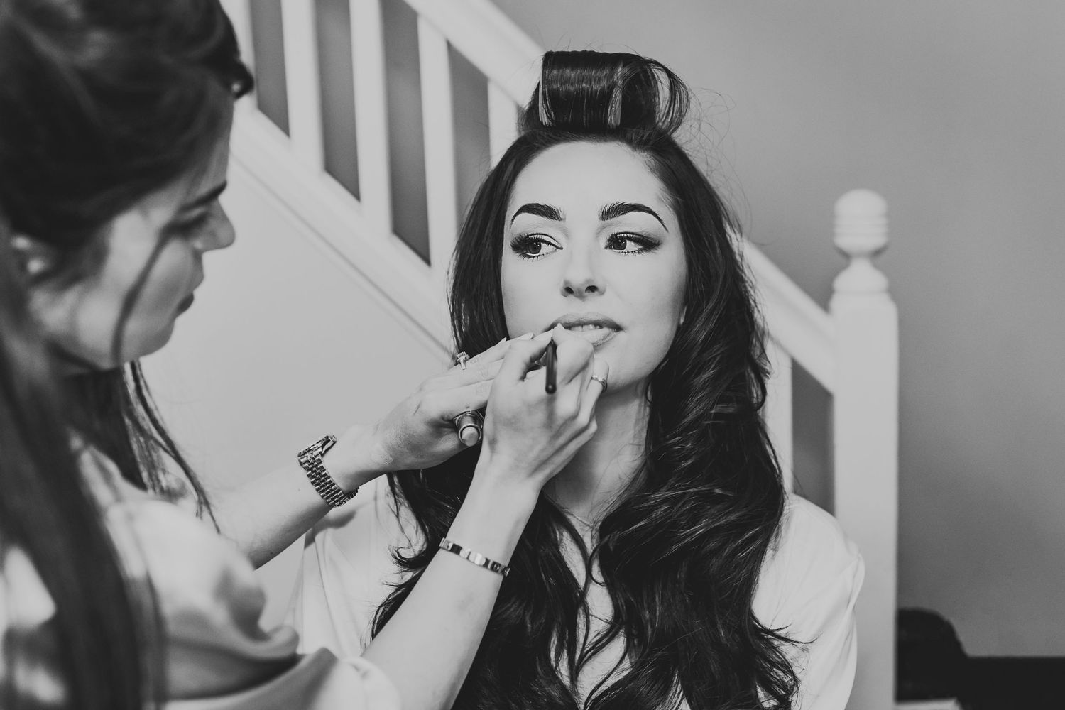 Black and white series of intimate wedding moments with newlyweds sharing playful interactions.