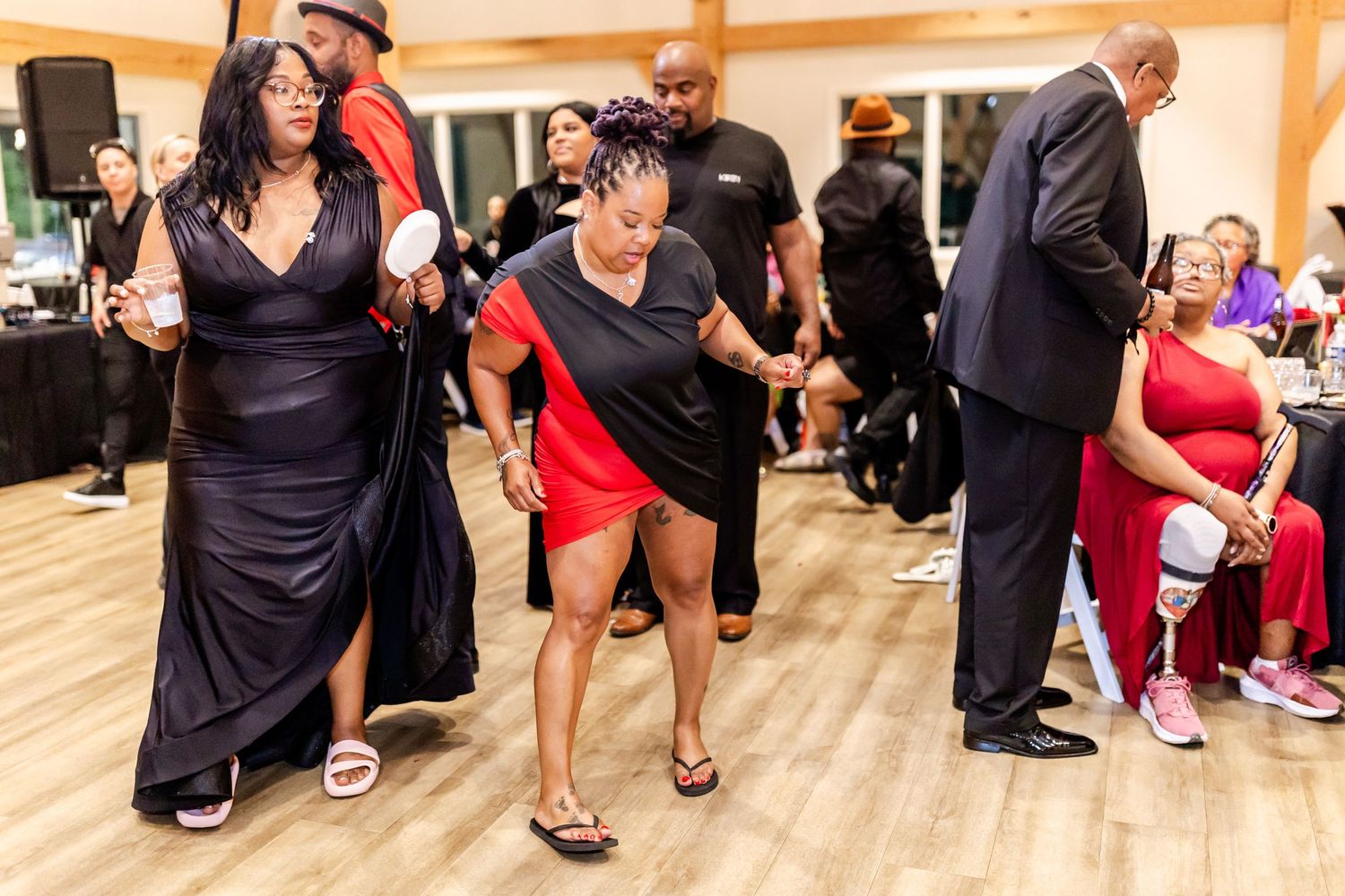 Guests enjoying themselves on the dance floor at an indoor wedding celebration.