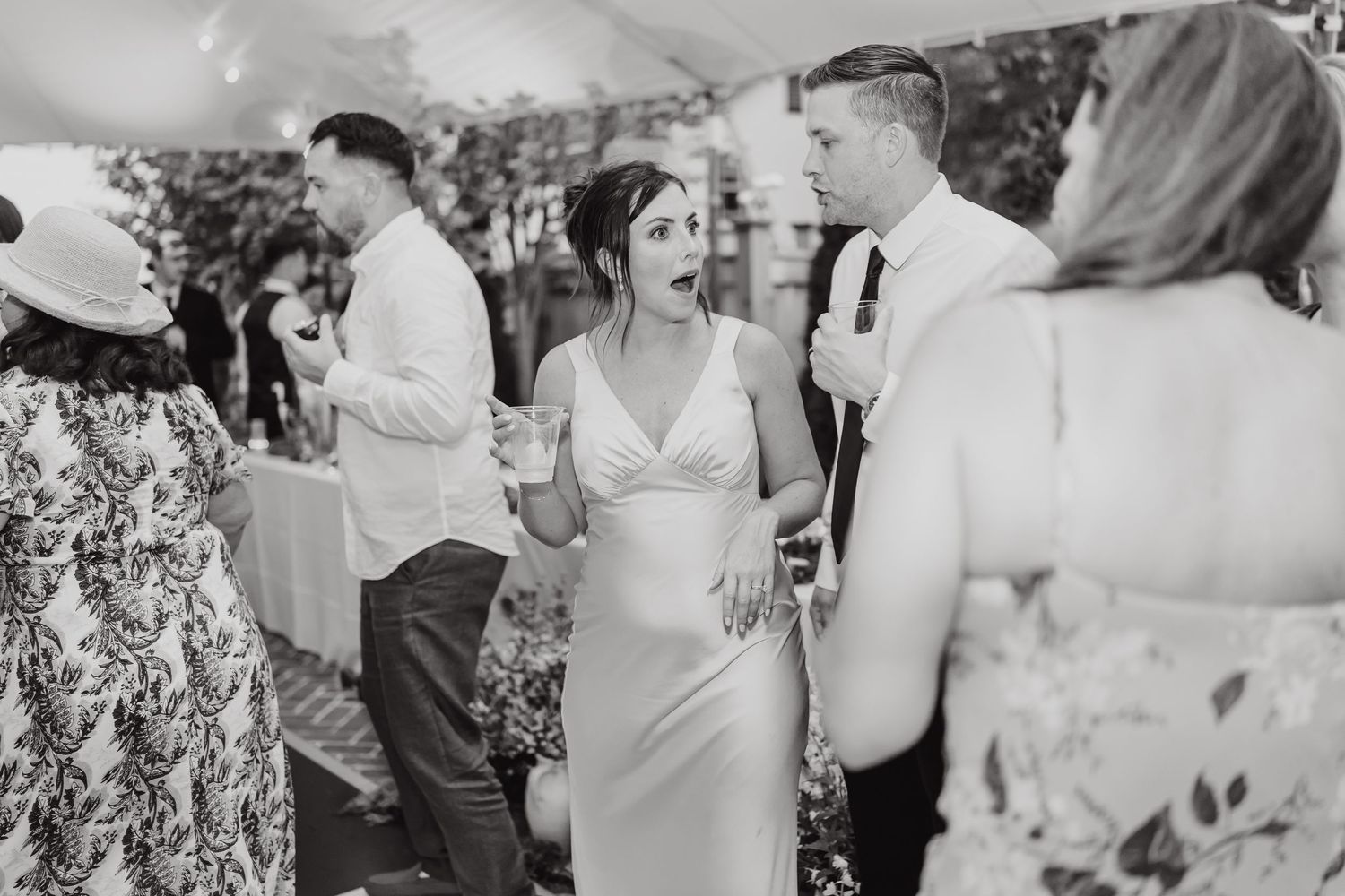 Wedding guests enjoying themselves on a dance floor at an outdoor celebration.