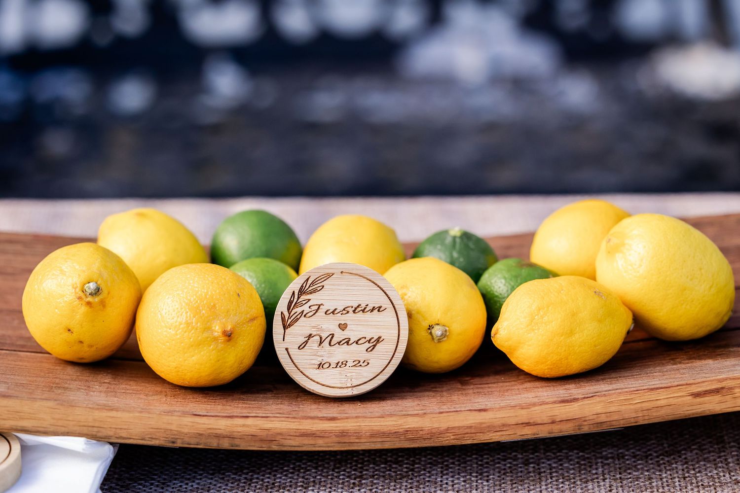 Fresh citrus fruits arranged on a rustic wooden board for wedding cocktail garnishes.