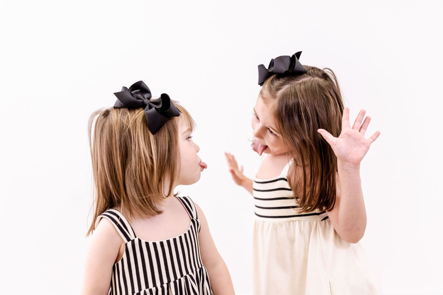 Four views showing a striped bow elastic hair accessory worn in different styling positions.