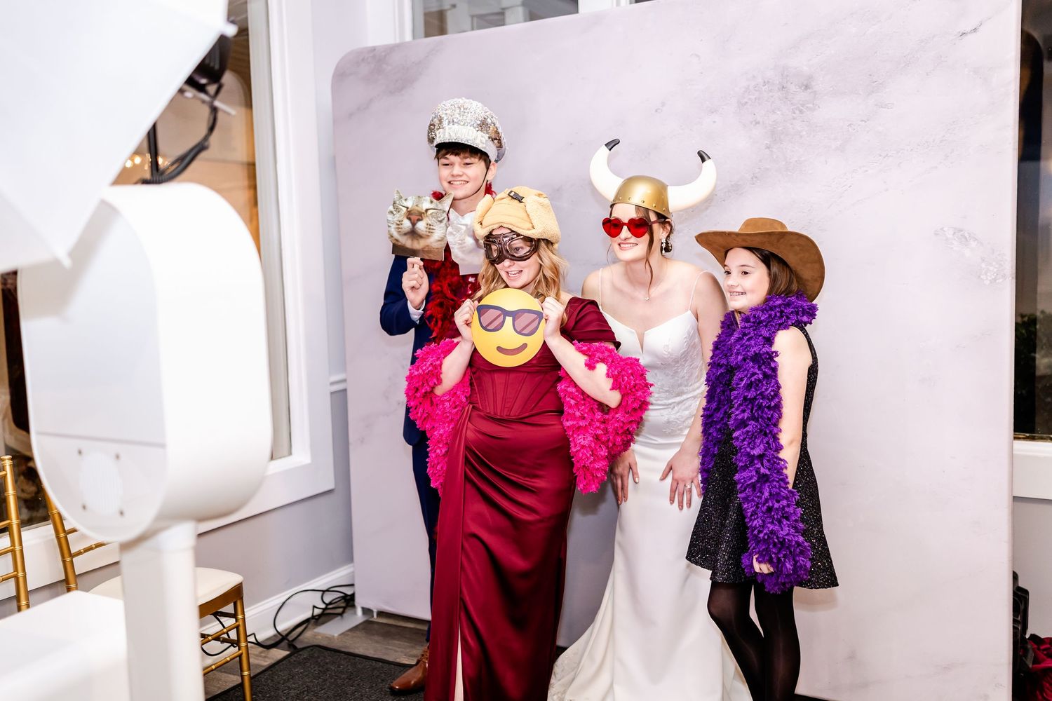 Wedding guests celebrating on the dance floor with colorful accessories and props.