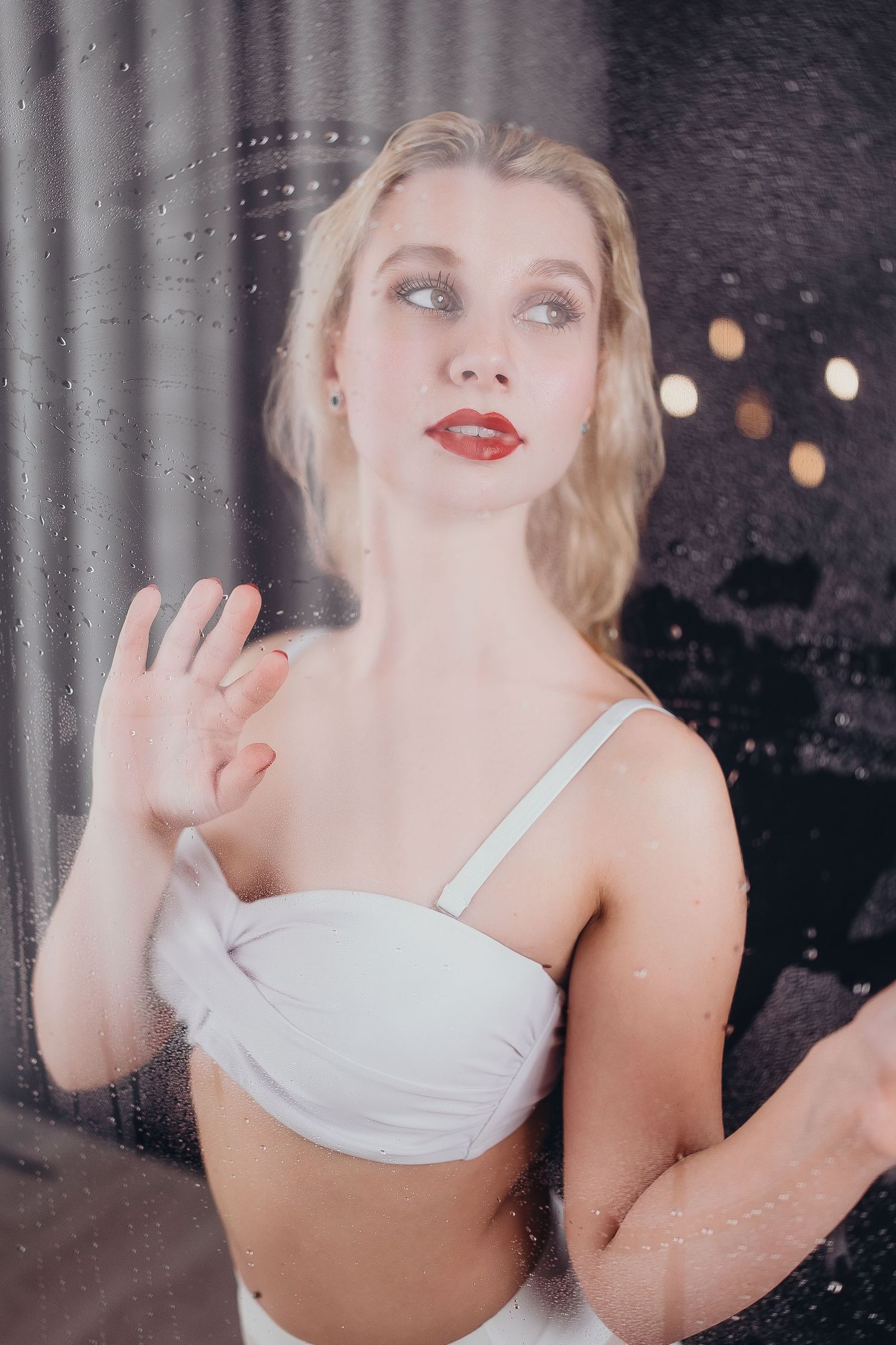 A series of glamour portraits showing a woman in a white top posing against a dark background with soft lighting.