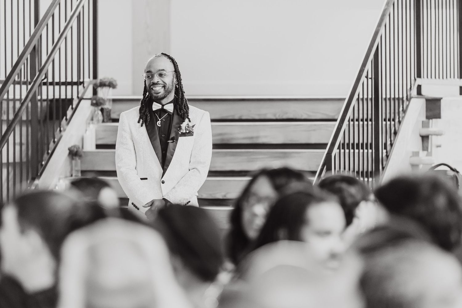 Black and white portrait of someone speaking at a formal event.