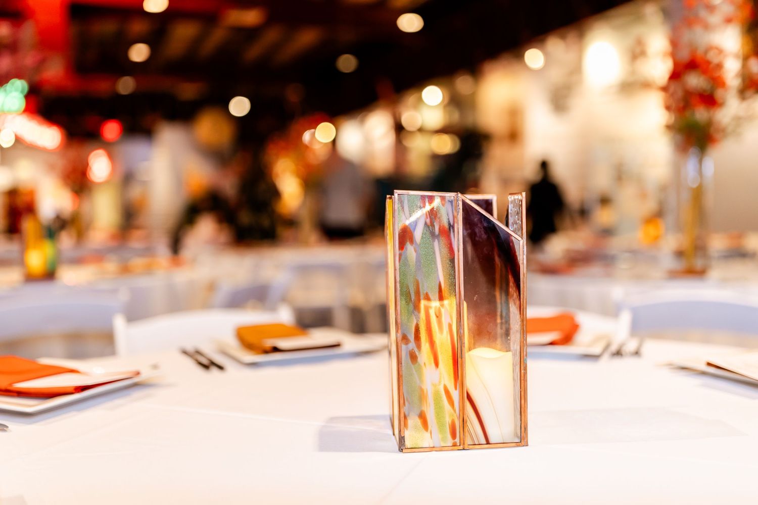 Close-up of an elegant table setting with menu card and place settings at a wedding reception.