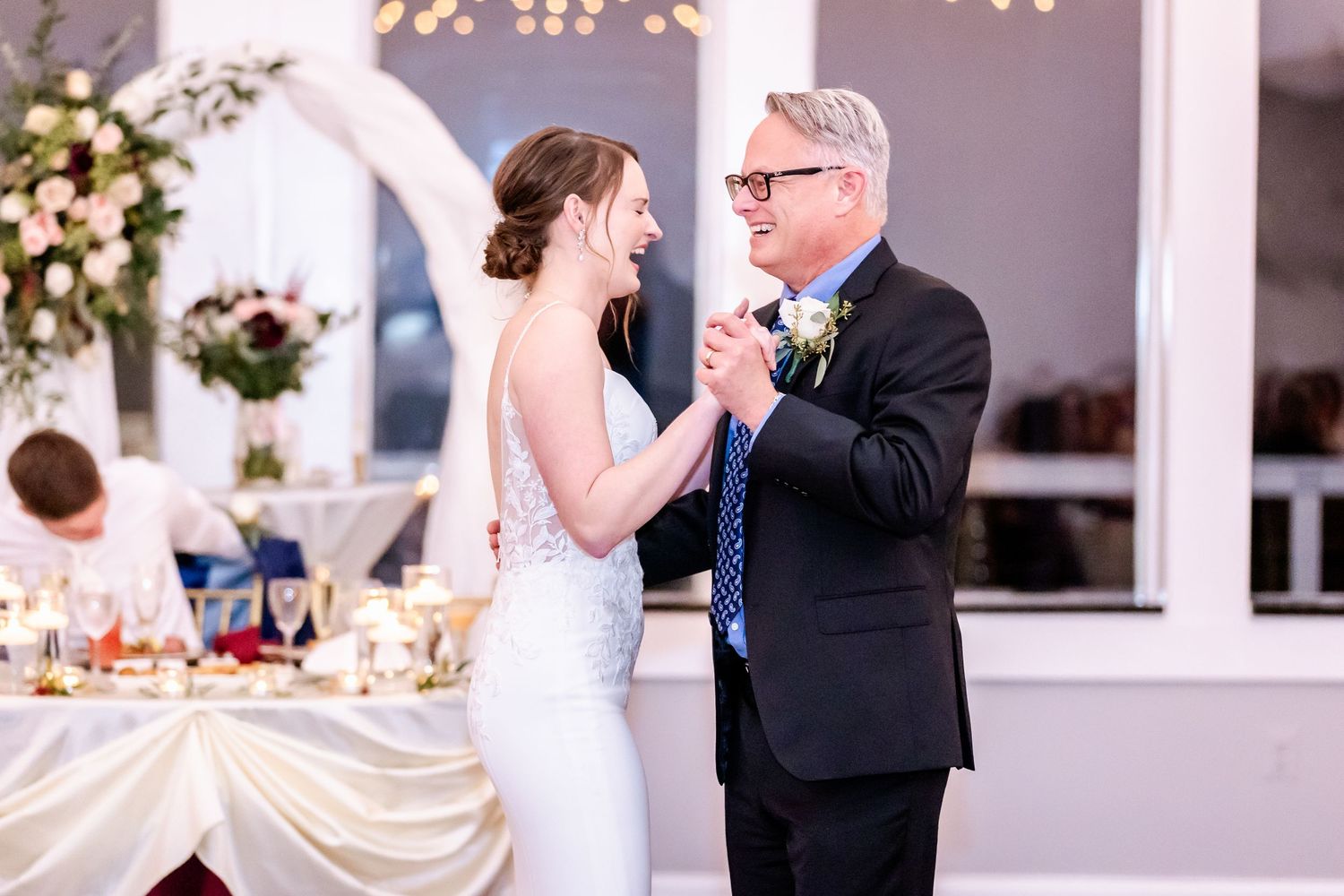 Wedding reception dance with elegant lighting and indoor decor.