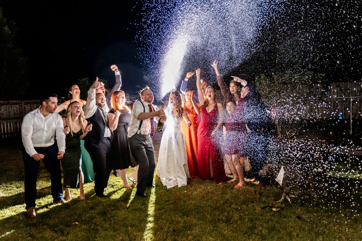 A nighttime celebration with sparklers creating magical light trails against a dark sky.