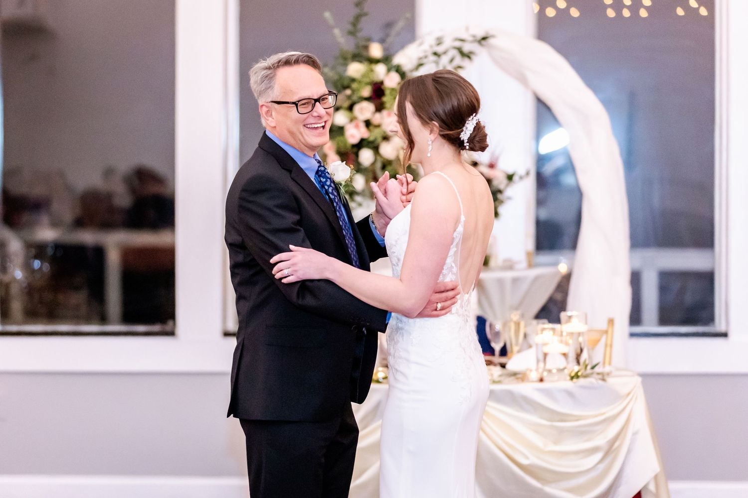 Wedding celebration in an elegant indoor venue with string lights and decorative touches.
