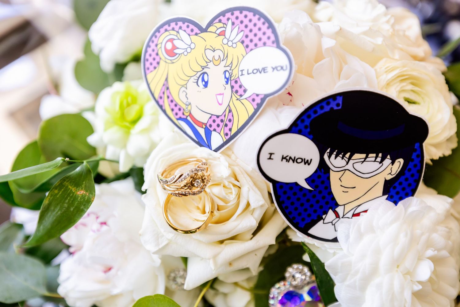 Anime character stickers placed among white roses and greenery in a wedding setting.