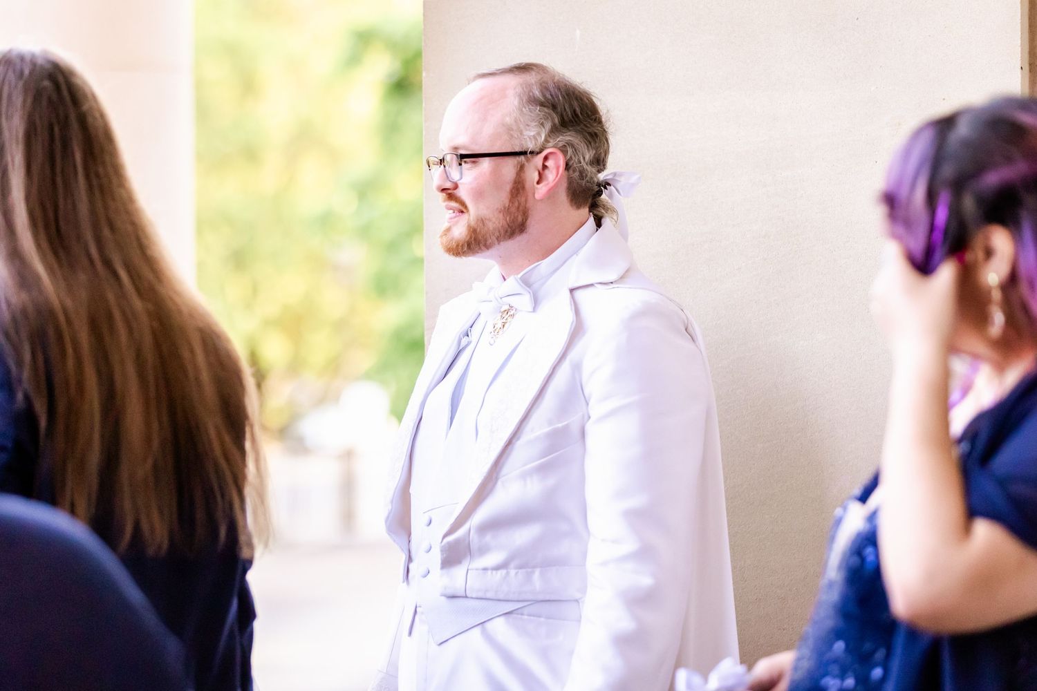 People gather in formal attire during wedding celebration.