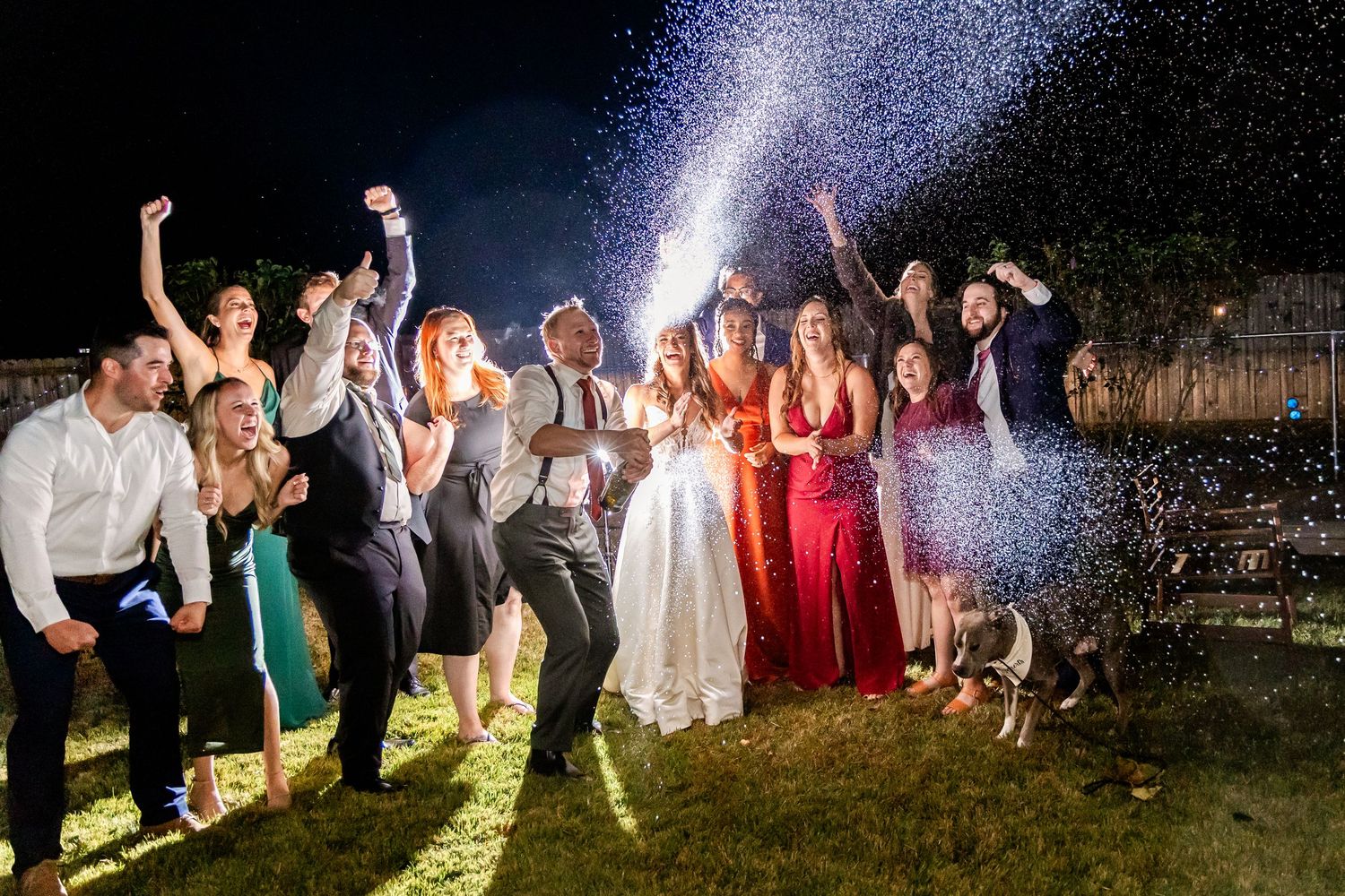 Wedding guests create sparkler exit tunnel at night with dramatic lighting effects.