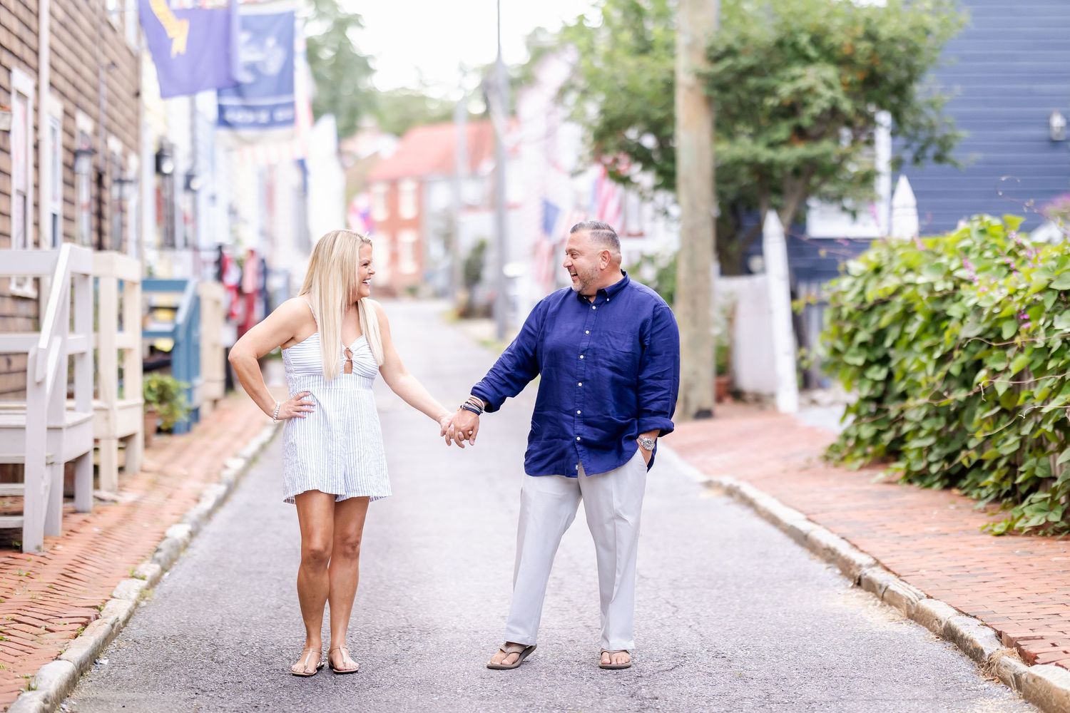 A series of candid photos taken on a charming cobblestone street showing people walking and interacting on a sunny day.