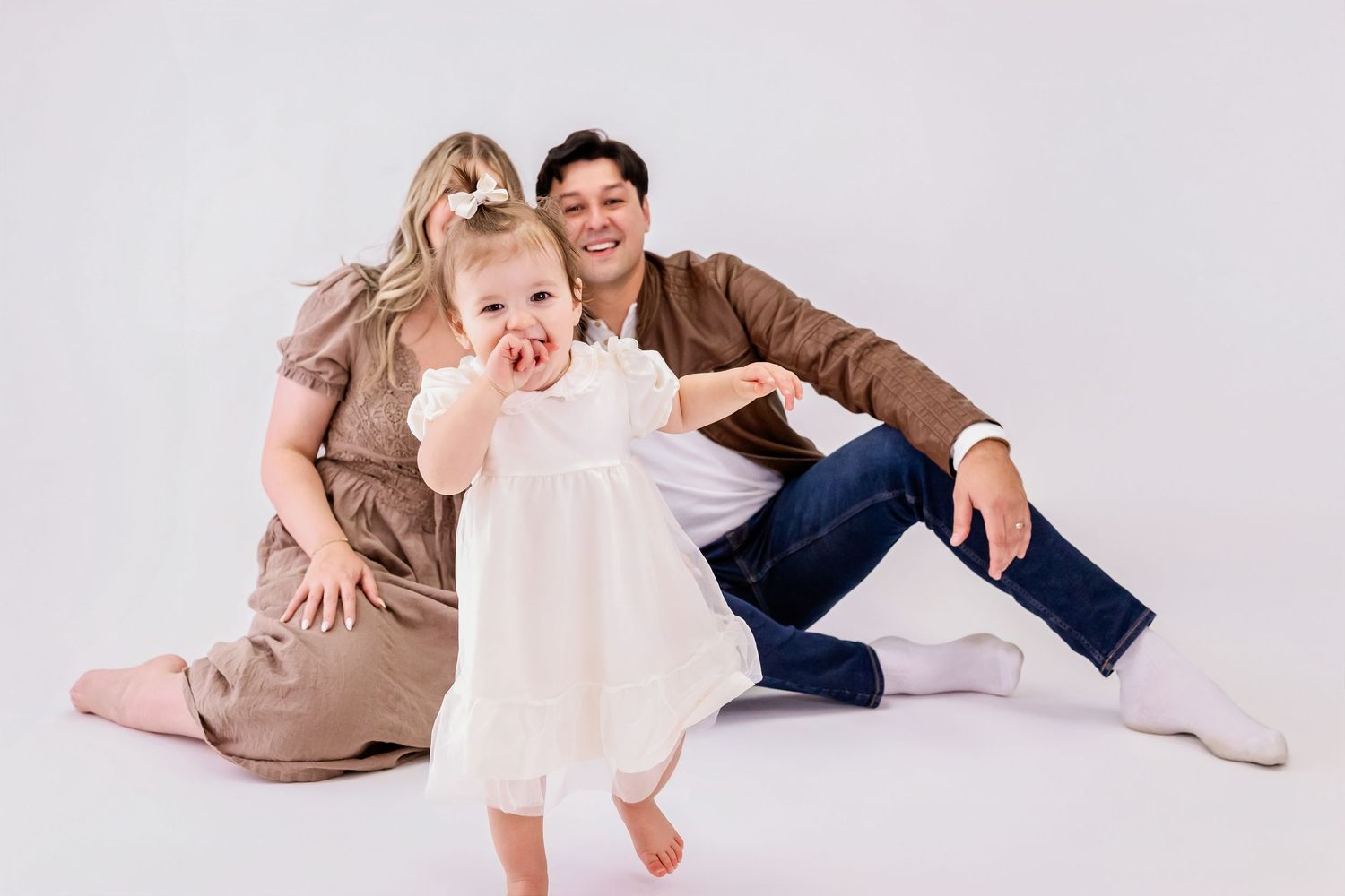 A collection of photos showing playful poses and movements on a white backdrop.