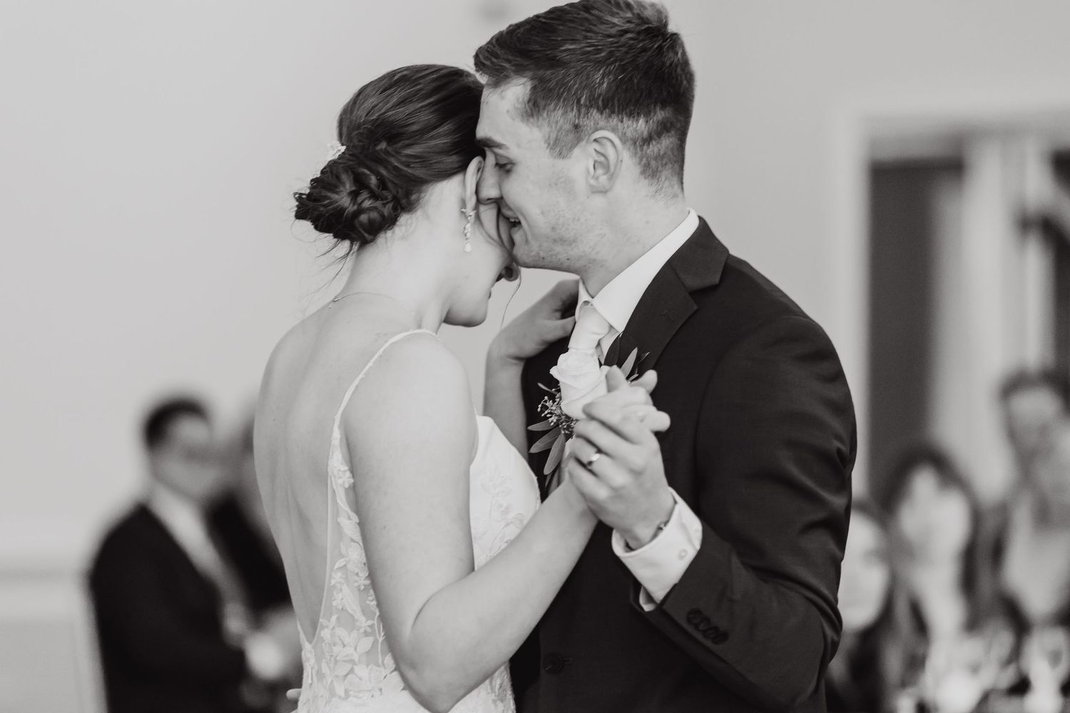 Intimate first dance moment captured in black and white at wedding reception.
