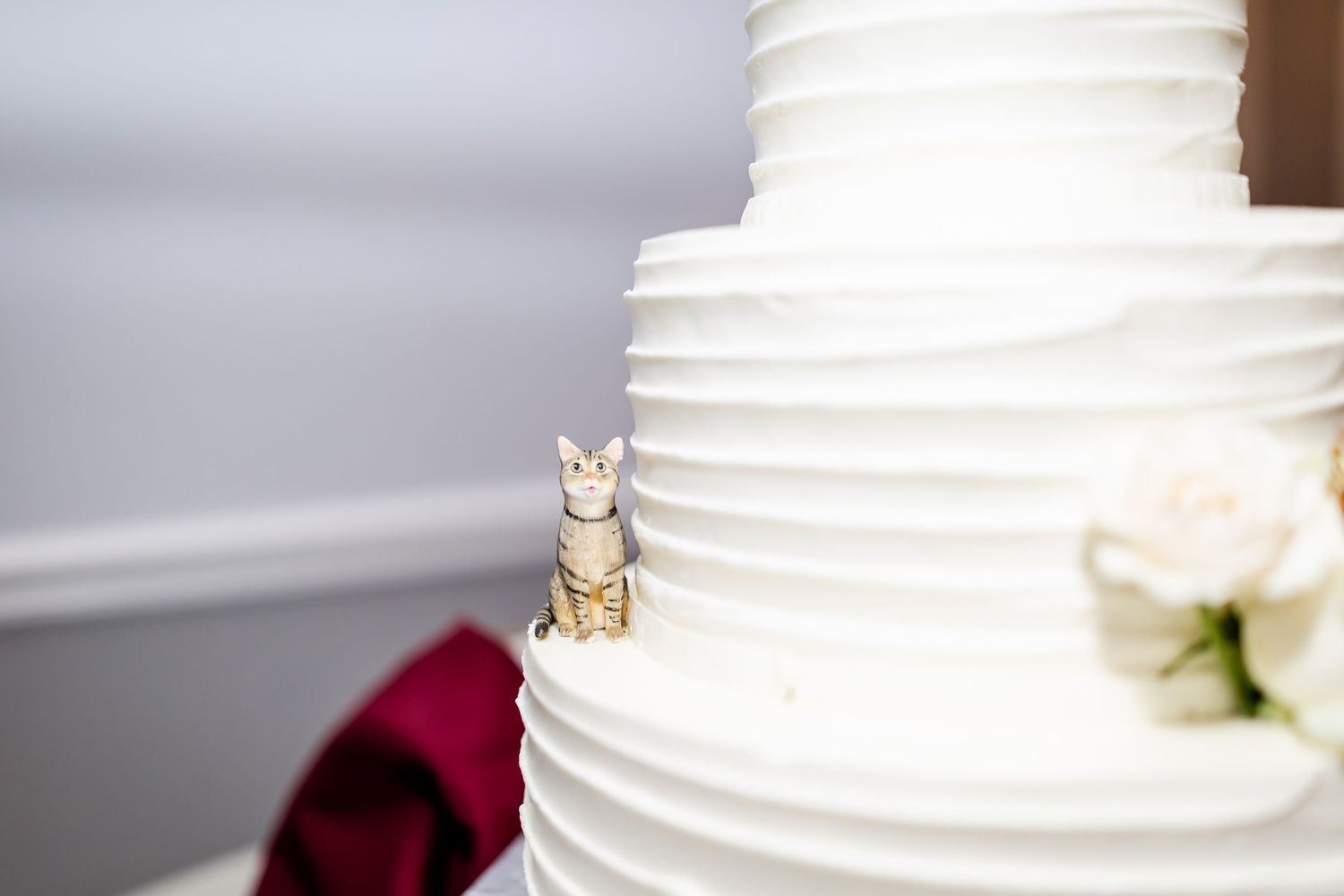 Close-up details of a white tiered wedding cake with textured frosting.