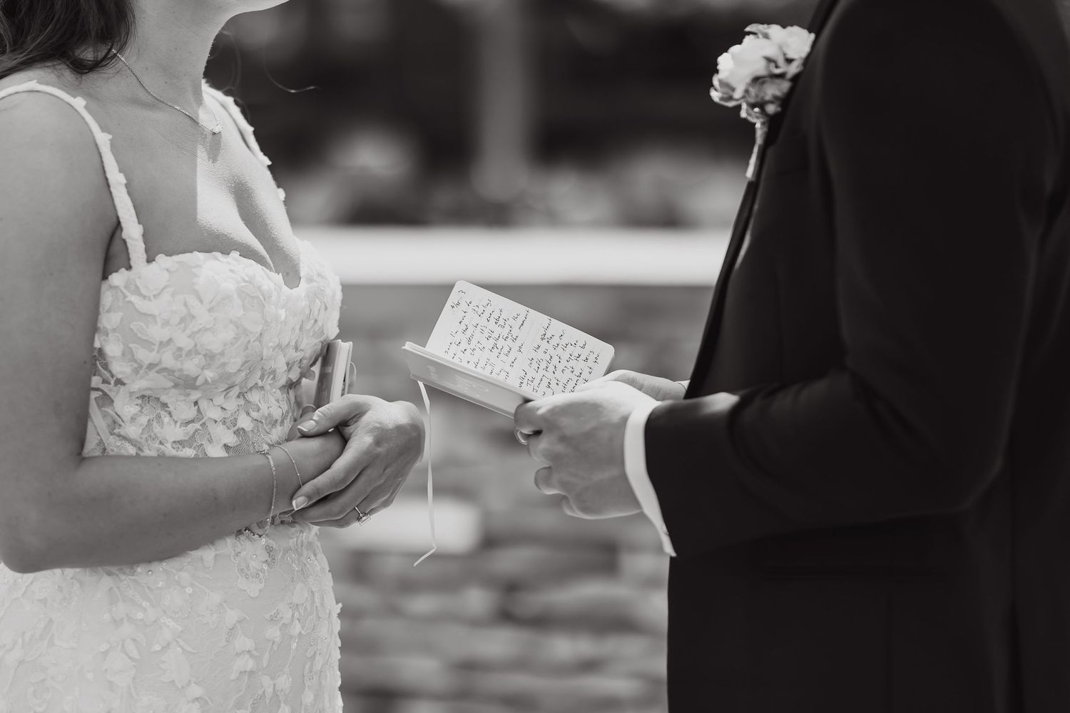 A collection of black and white wedding photos showing hands exchanging rings and holding bouquets during a ceremony.