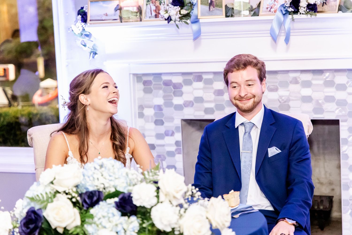 Elegant reception venue with white draped ceiling and guests dancing in formal attire.