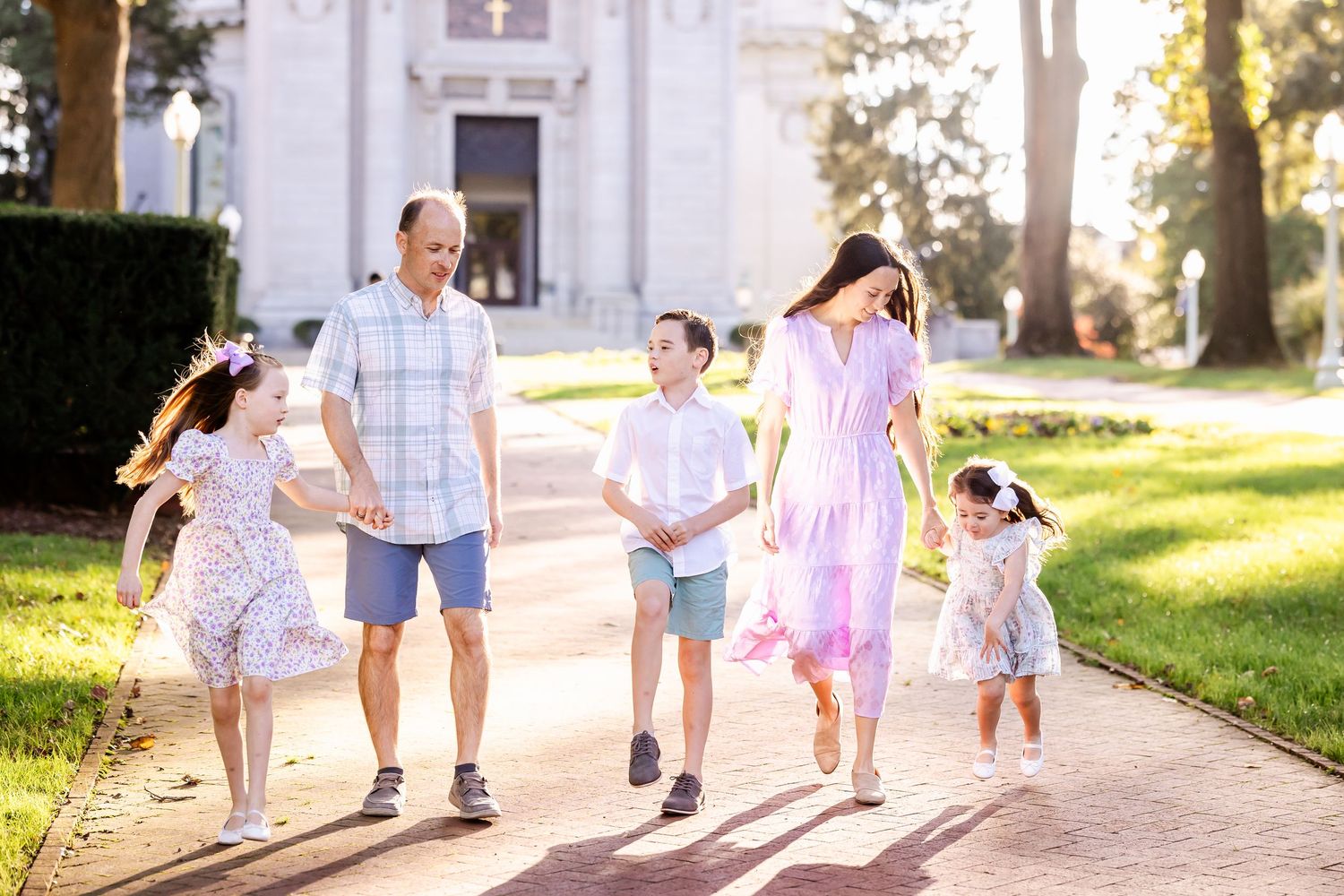 Children walking and playing together on a sunny path outdoors.