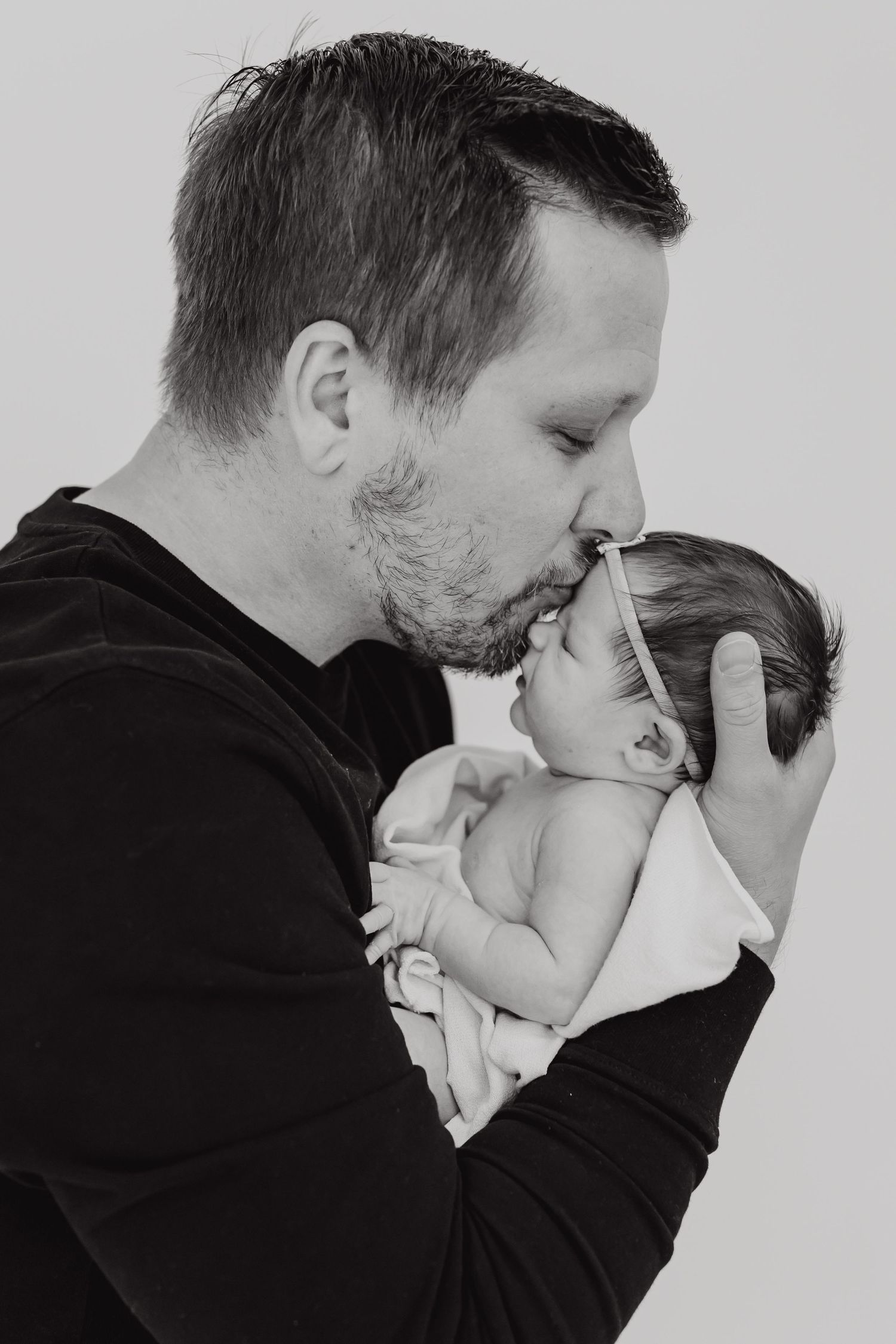 A series of intimate black and white images showing a couple engaged in tender romantic moments.