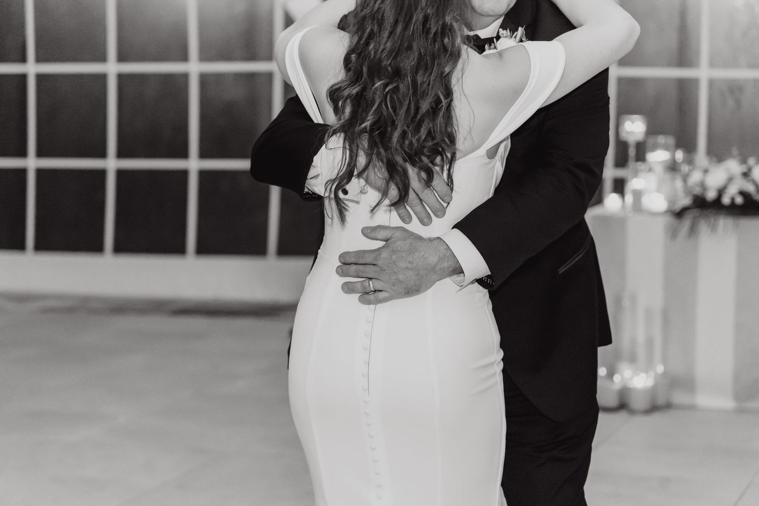 Black and white photo of a couple dancing during their wedding reception.