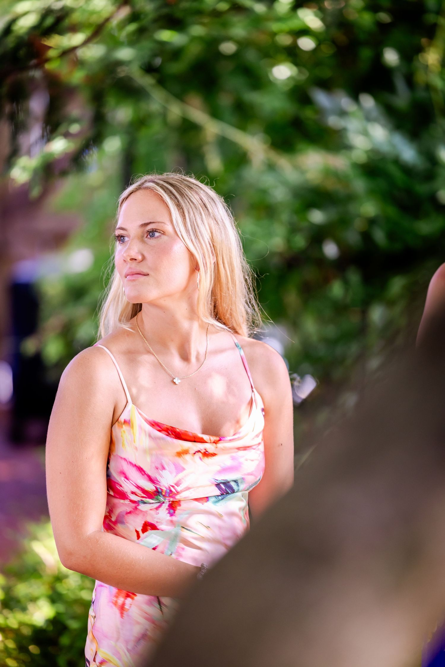 Close up portrait shots in a garden setting with soft natural lighting and greenery.