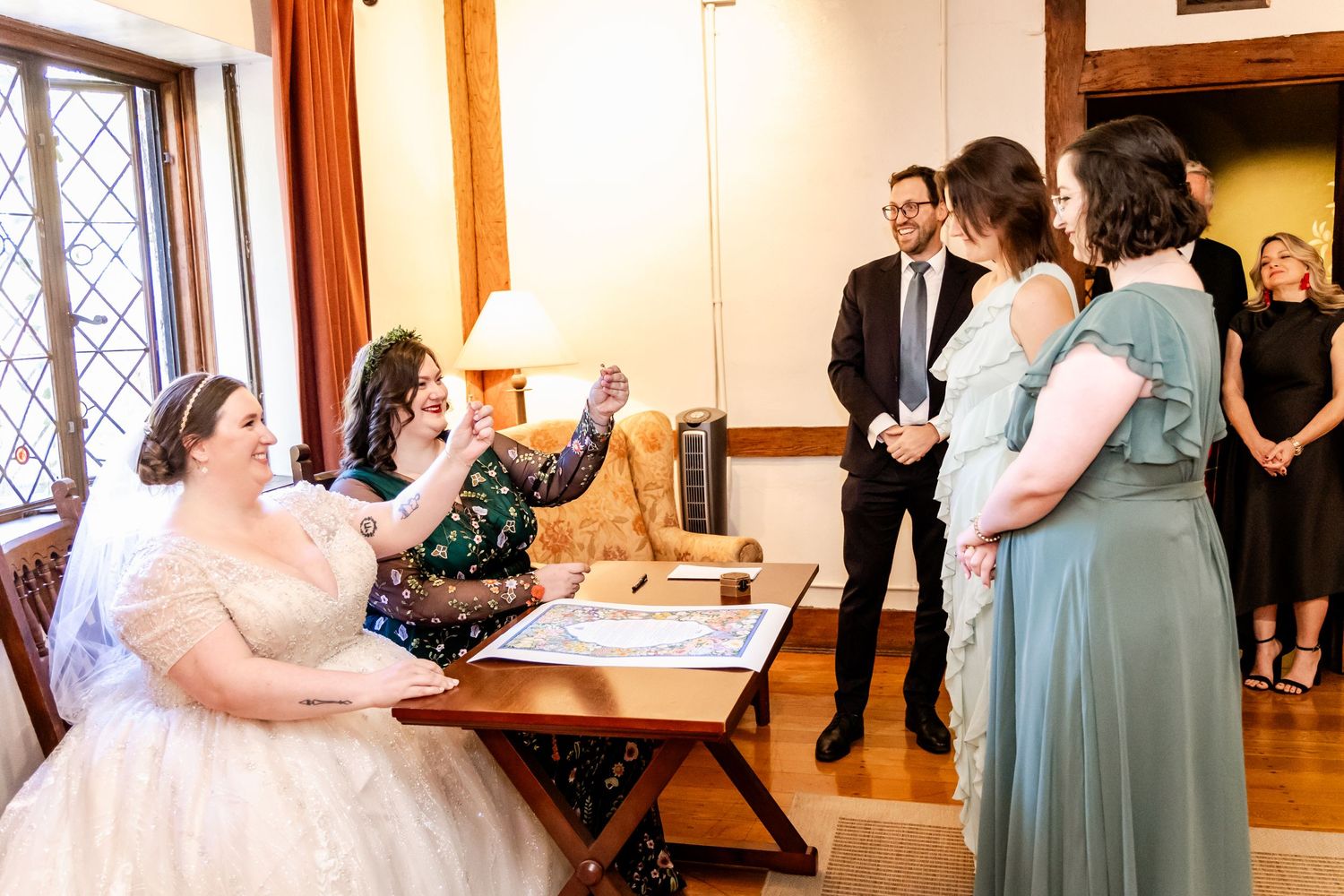 A wedding ceremony scene inside a rustic room with wooden details and vintage windows.