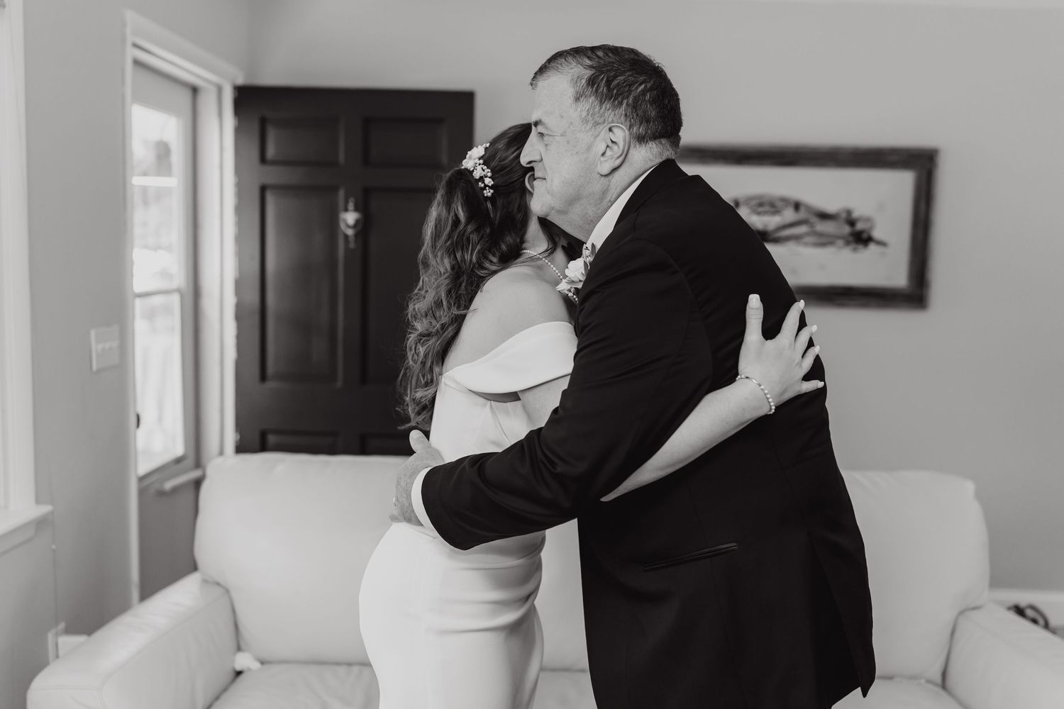 Emotional black and white wedding portraits in an elegant indoor setting.