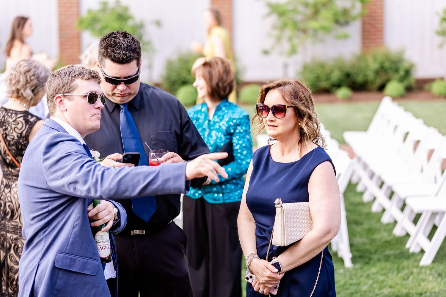 Guests enjoying conversation during an outdoor wedding reception.