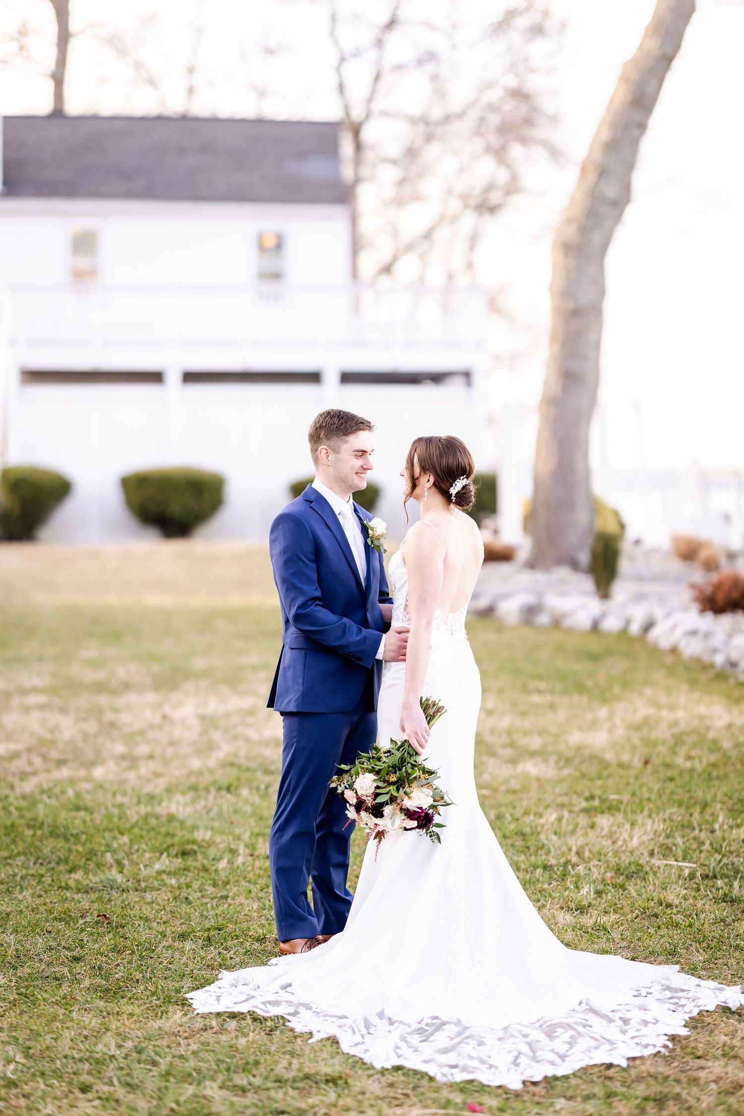 A bride and groom share a romantic moment outdoors on their wedding day.