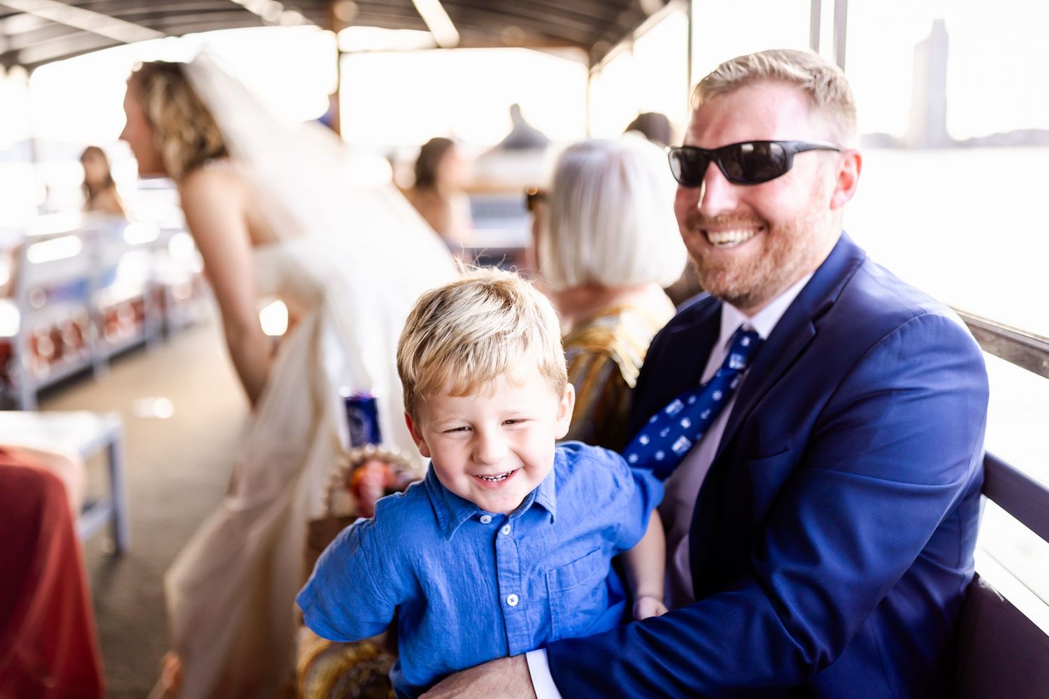 A joyful moment shared between two passengers on a boat during a sunny afternoon.