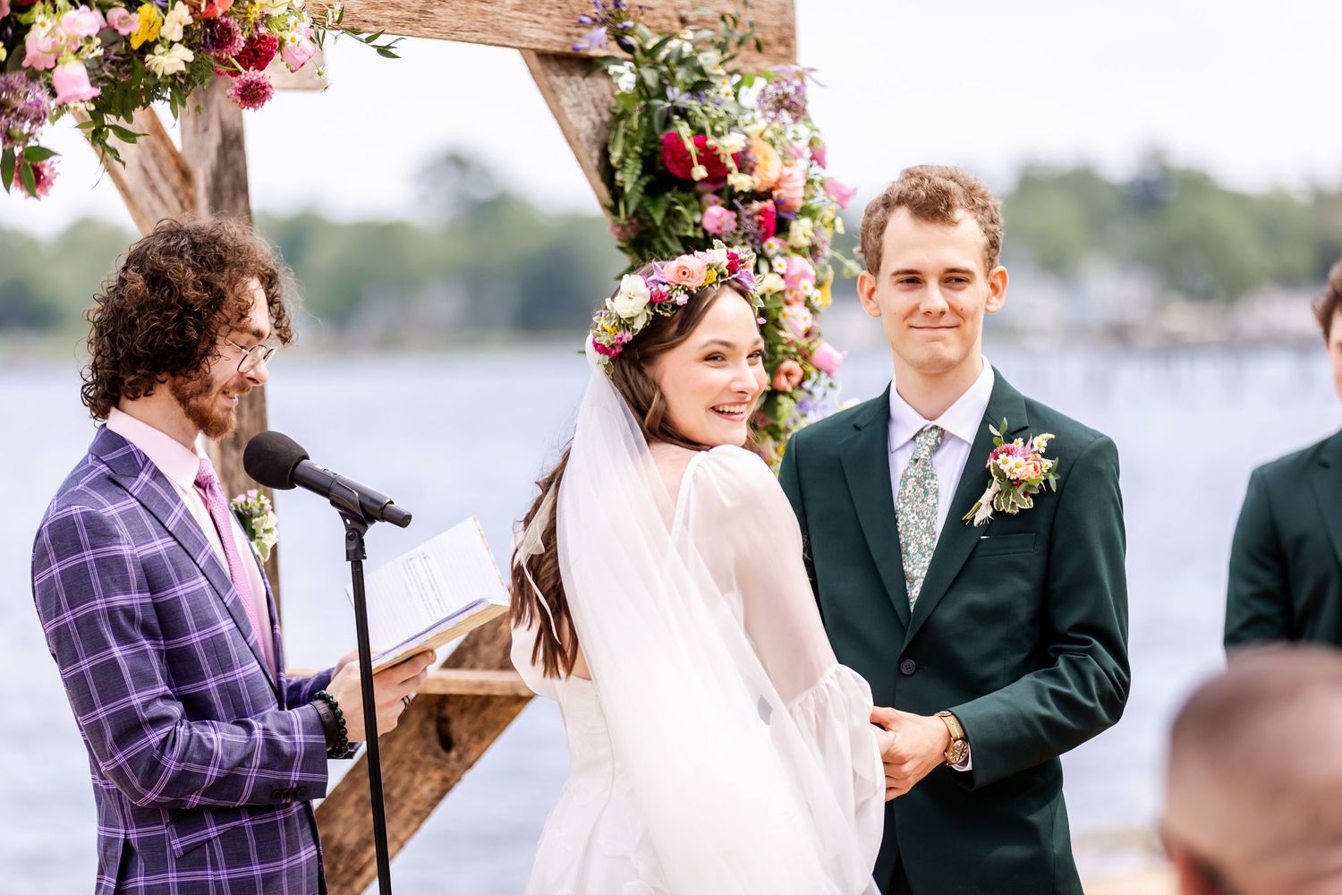 Collage of outdoor wedding ceremony moments with floral decorations and waterfront views in the background.