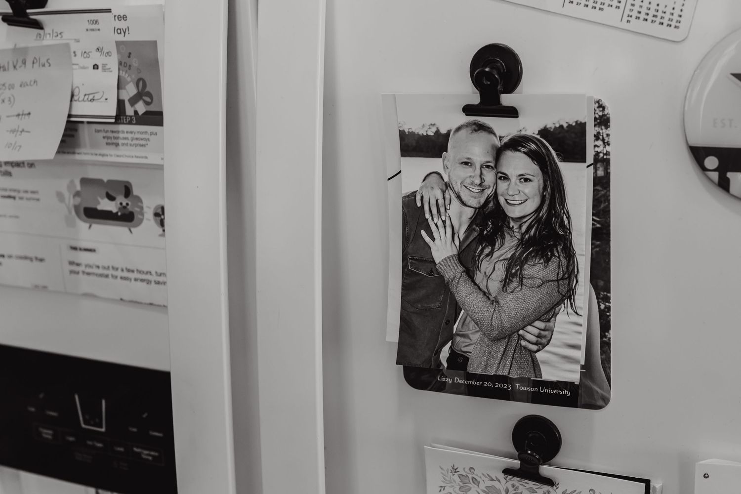 Black and white photos displayed on a white wall showing wedding memories.
