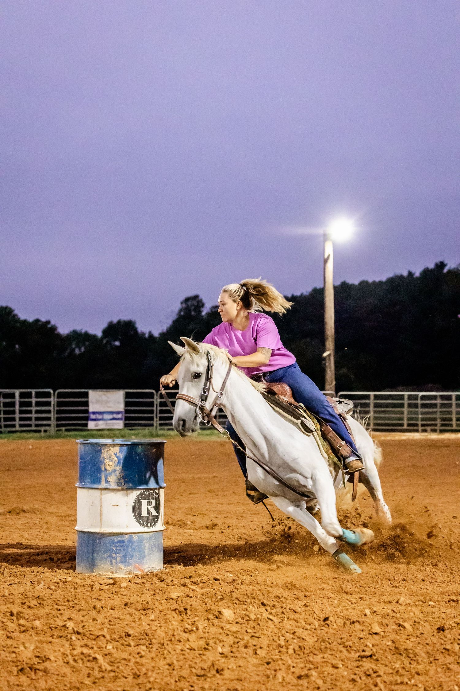 Sequential shots of barrel racing run showing horse and rider making dramatic turn in evening light.