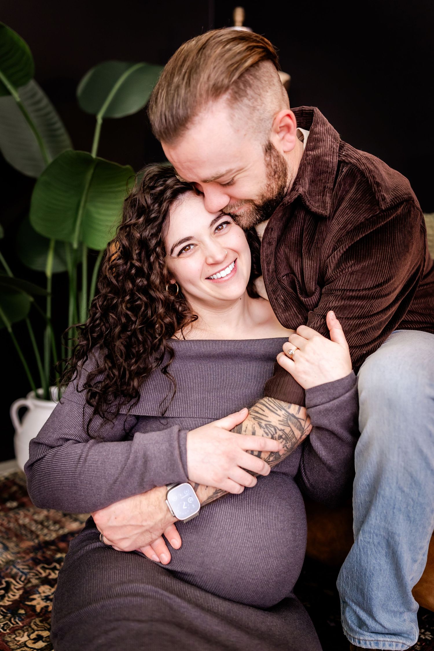 Intimate maternity photos showing couple embracing with joy.