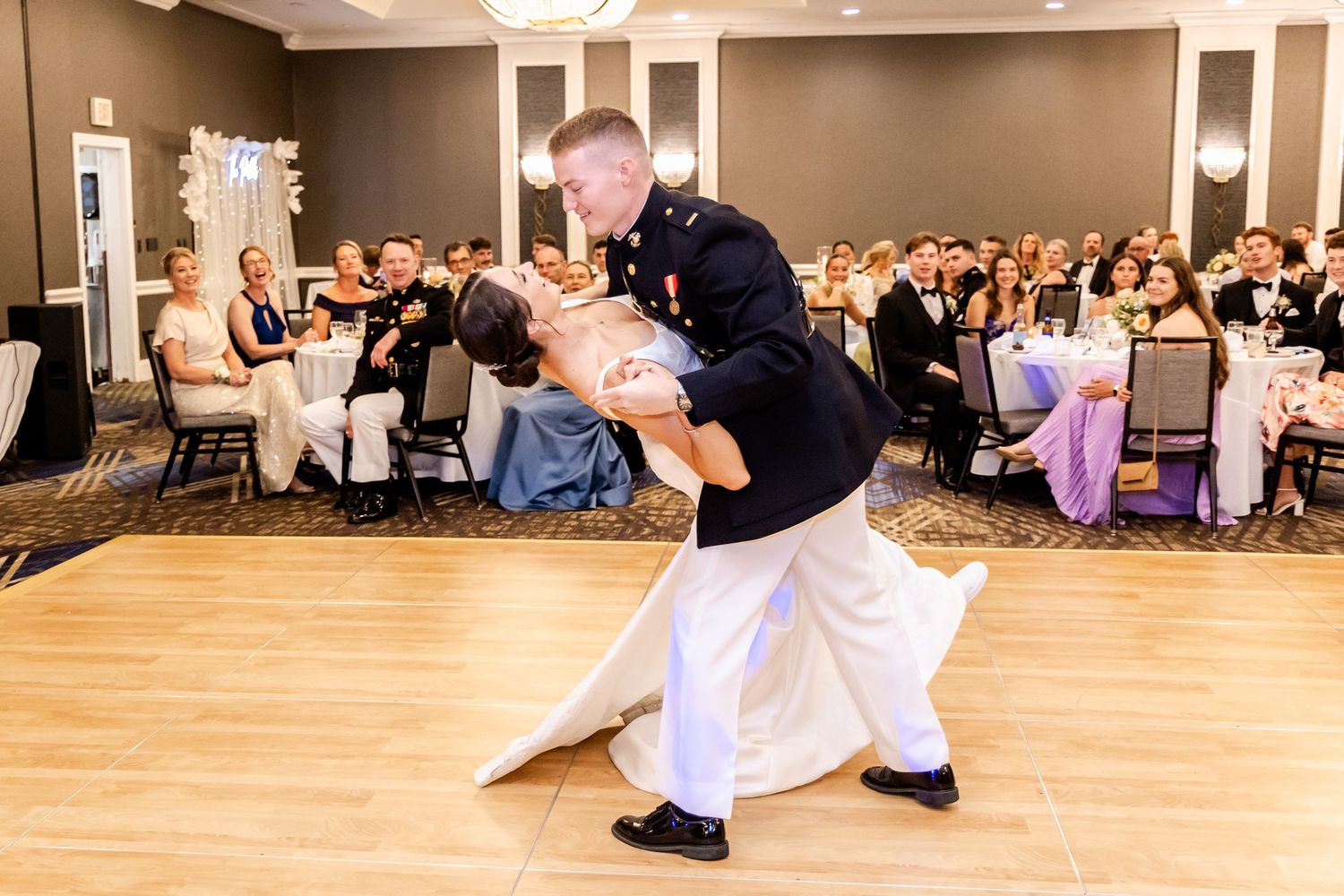 Wedding reception dance floor moments with guests celebrating in a ballroom setting.