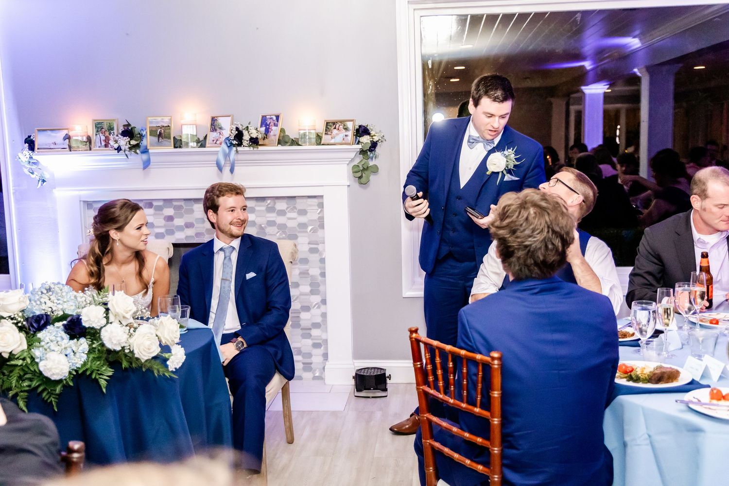 Reception dinner scene with elegant table settings and white hydrangea centerpieces.
